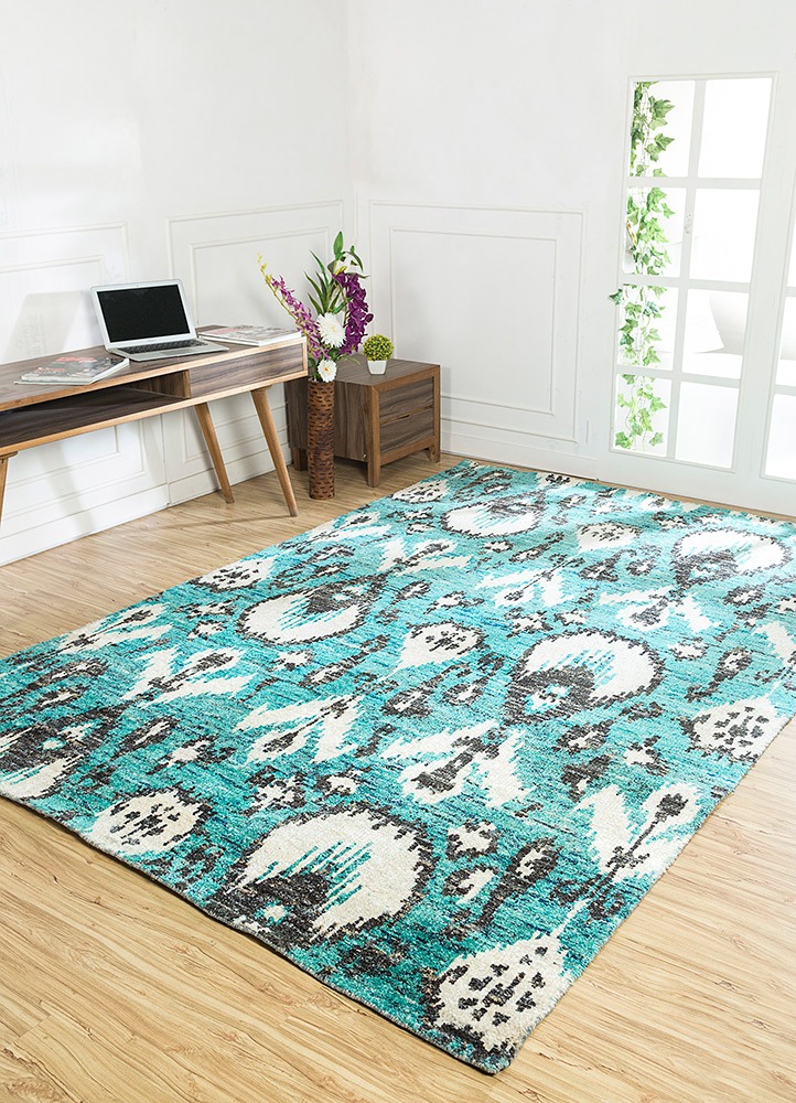 Turquoise patterned designer rug from Jaipur Rugs in living room