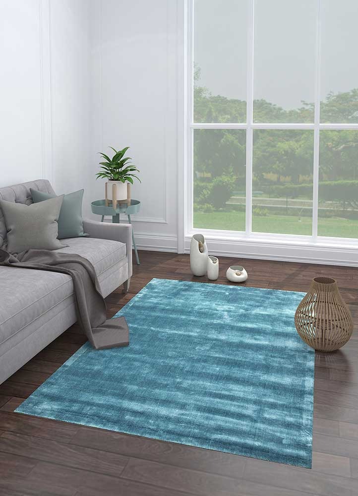 Turquoise blue rug from Jaipur Rugs in living room